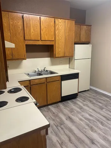 a kitchen with a sink a stove and cabinets