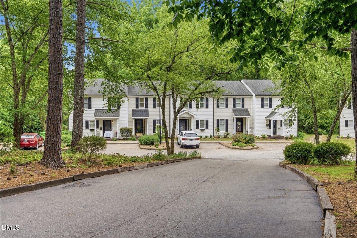 2834 Wayland Drive Raleigh, NC 27608 - Photo 2 of 26 a front view of a house with a garden and trees
