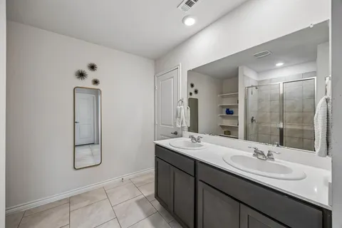 a bathroom with 2 sink and a mirror