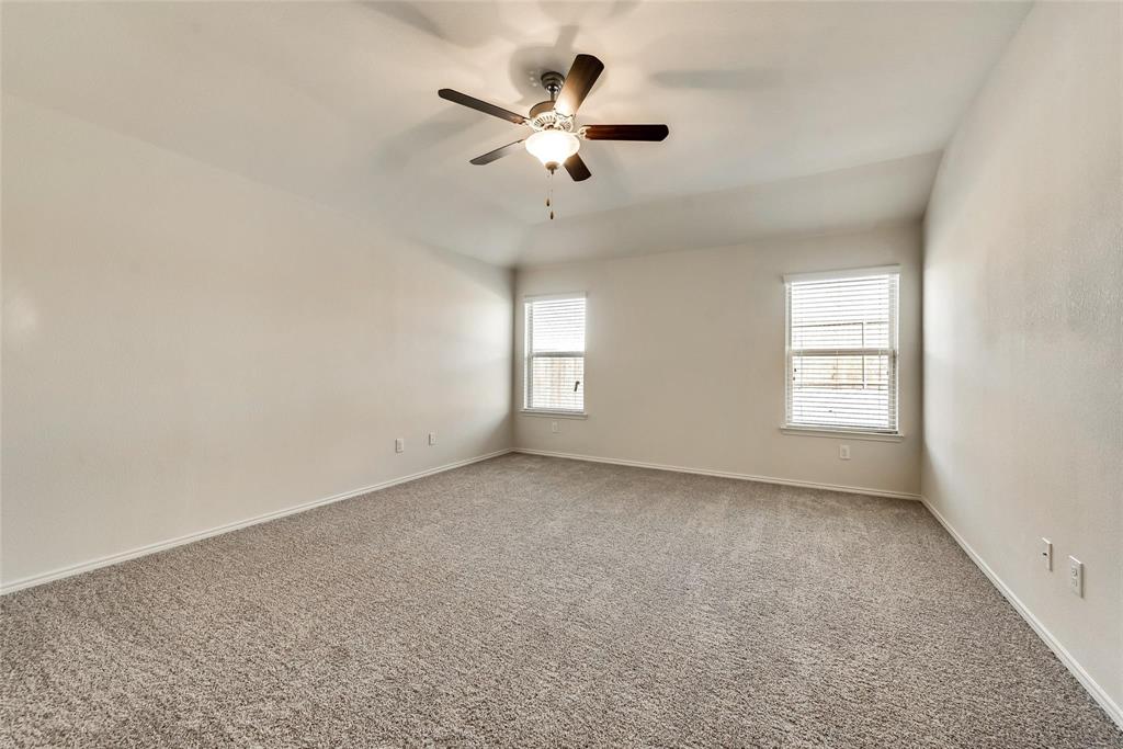 233 Pitt Circle Fate, TX 75189 - Photo 11 of 21 an empty room with windows and ceiling fan
