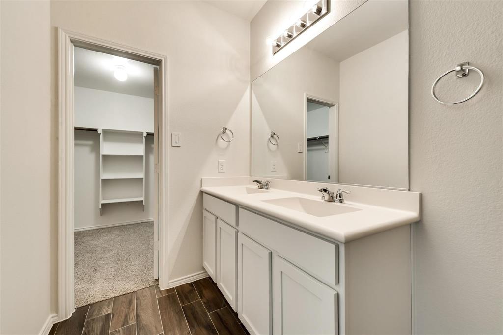 233 Pitt Circle Fate, TX 75189 - Photo 14 of 21 a bathroom with a sink and a mirror