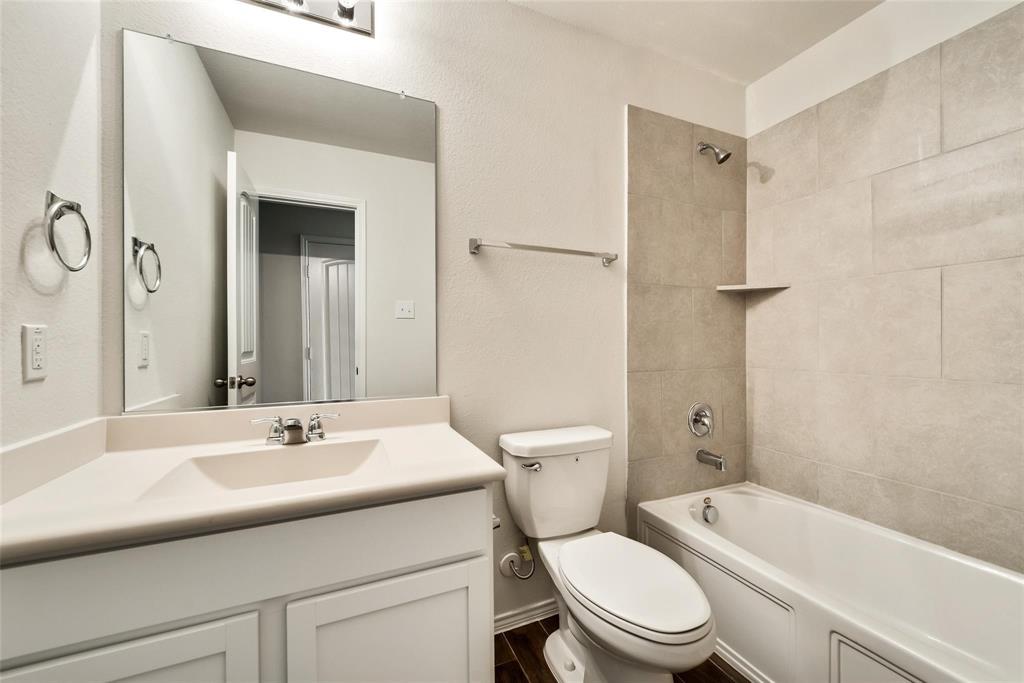 233 Pitt Circle Fate, TX 75189 - Photo 18 of 21 a bathroom with a sink toilet and shower