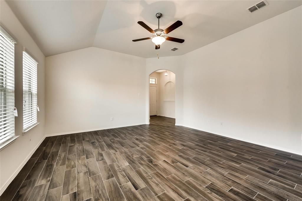 233 Pitt Circle Fate, TX 75189 - Photo 2 of 21 a view of empty room with wooden floor and fan