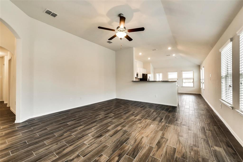 233 Pitt Circle Fate, TX 75189 - Photo 3 of 21 a view of empty room with wooden floor and fan