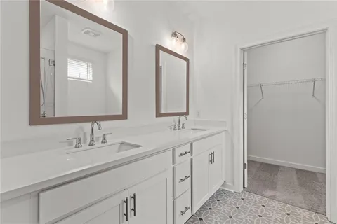a bathroom with a double vanity sink and mirror