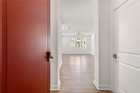 a view of an empty room and wooden floor