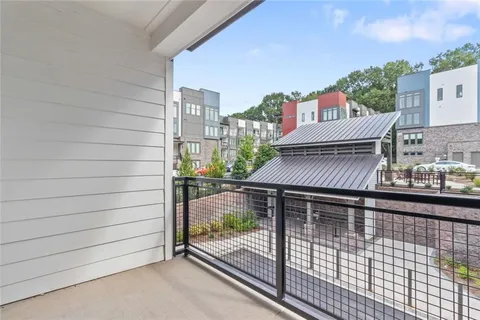 a view of a balcony with a floor to ceiling window and wooden floor