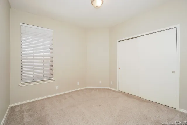 an empty room with windows and closet