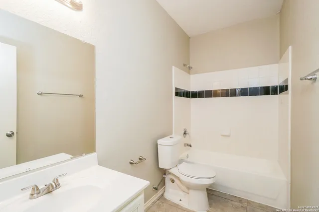 a bathroom with a sink a toilet and shower curtain