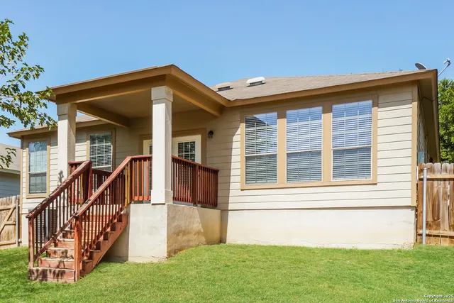 a view of house with backyard