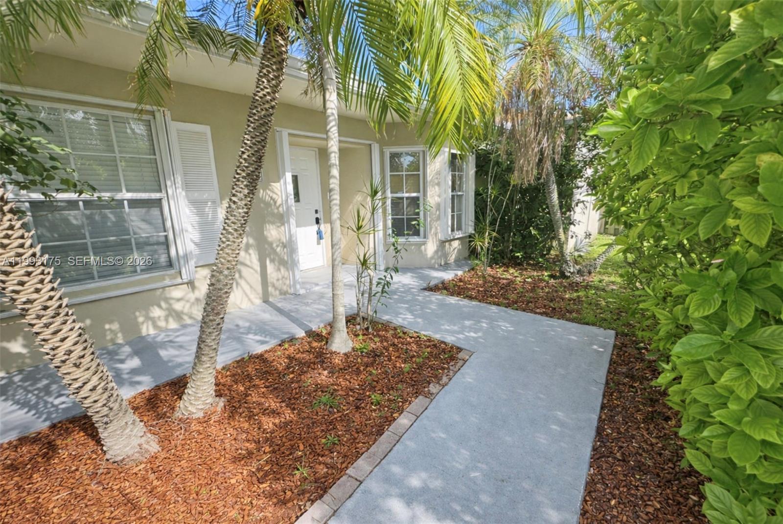 12695 Southwest 144th Terrace Miami, FL 33186 - Photo 1 of 43 a front view of a house with a yard