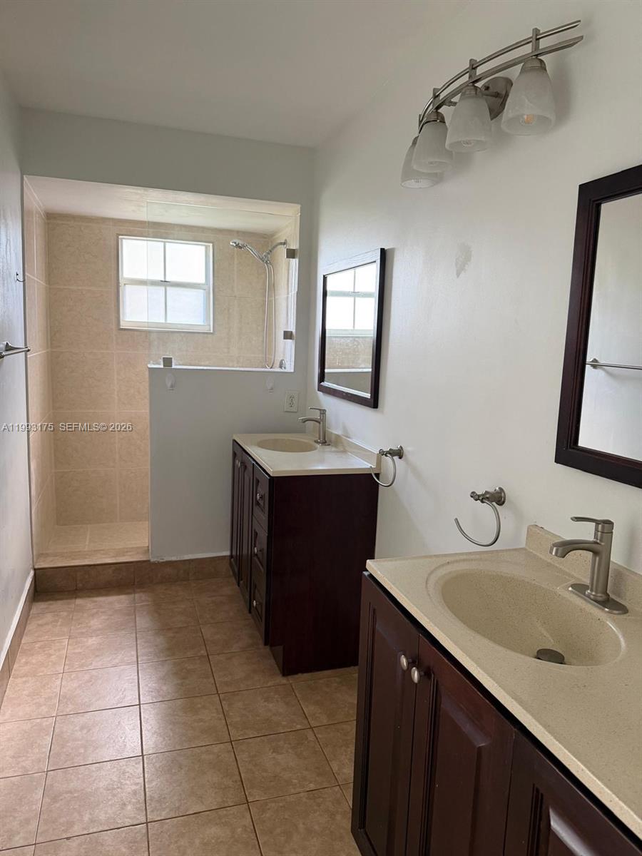 12695 Southwest 144th Terrace Miami, FL 33186 - Photo 11 of 43 a bathroom with a sink vanity and a mirror