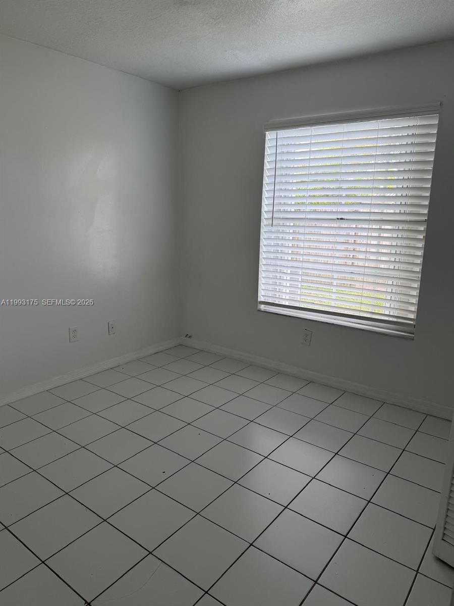 12695 Southwest 144th Terrace Miami, FL 33186 - Photo 14 of 43 an empty room with a window