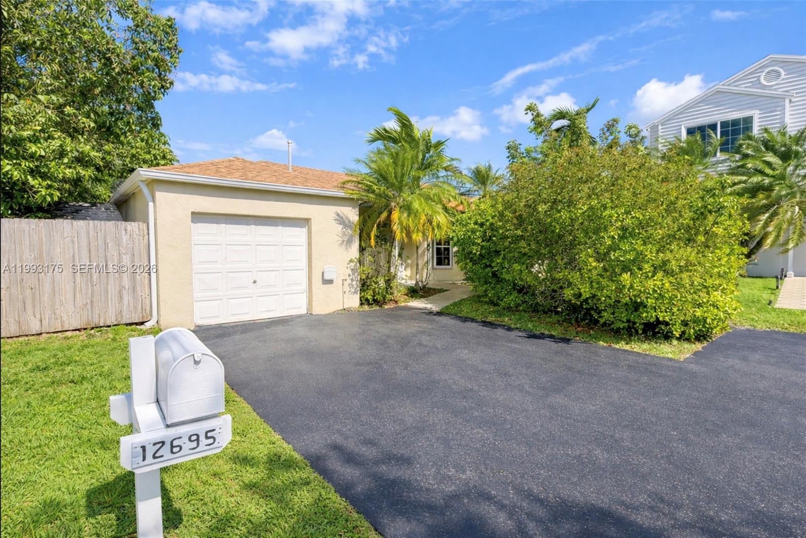 12695 Southwest 144th Terrace Miami, FL 33186 - Photo 2 of 43 a front view of a house having yard