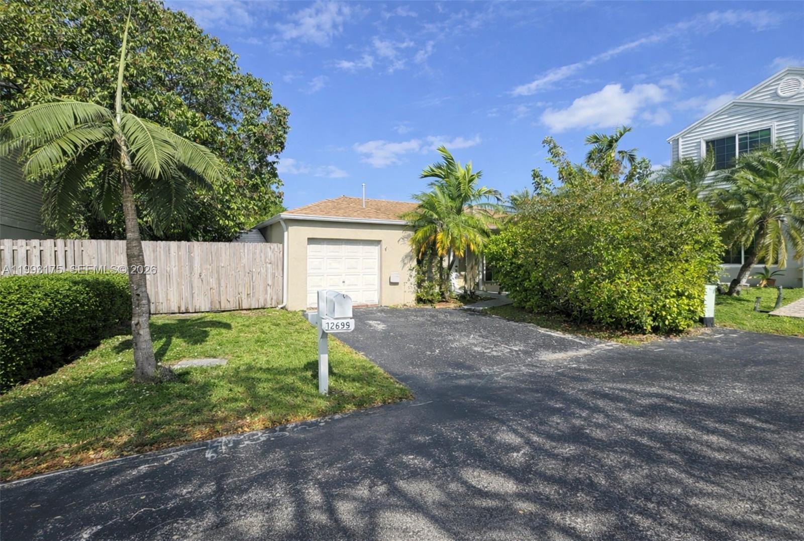 12695 Southwest 144th Terrace Miami, FL 33186 - Photo 23 of 43 a view of a house with a yard and plants