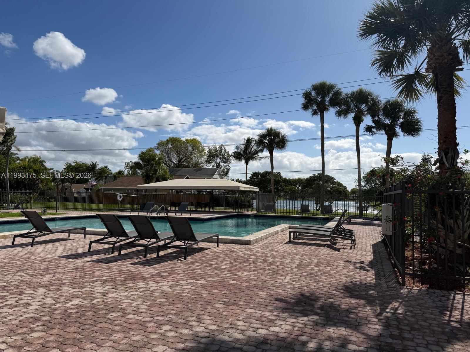 12695 Southwest 144th Terrace Miami, FL 33186 - Photo 25 of 43 a view of a lake with outdoor seating