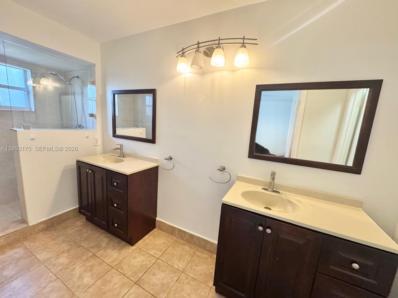 12695 Southwest 144th Terrace Miami, FL 33186 - Photo 32 of 43 a bathroom with a double vanity sink and mirror
