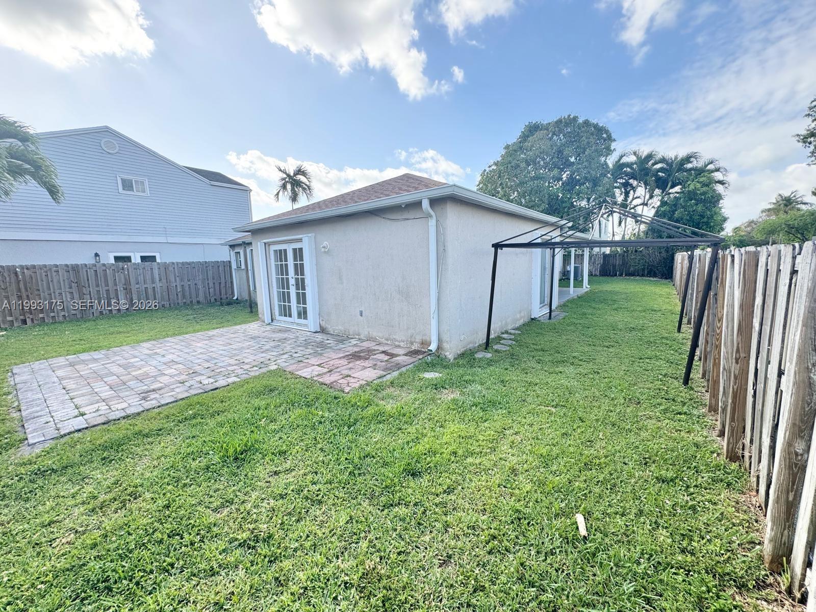 12695 Southwest 144th Terrace Miami, FL 33186 - Photo 33 of 43 a view of a backyard with potted plants and large tree