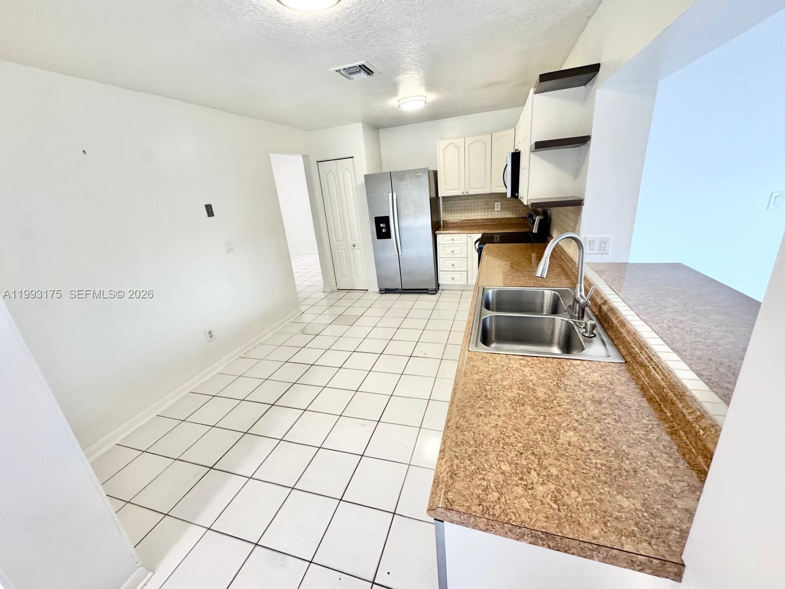 12695 Southwest 144th Terrace Miami, FL 33186 - Photo 35 of 43 a living room with a couch and a rug