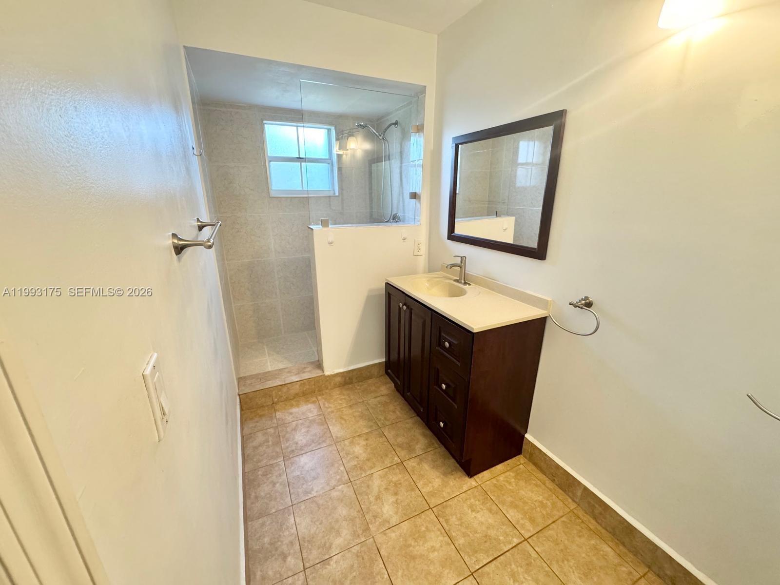 12695 Southwest 144th Terrace Miami, FL 33186 - Photo 39 of 43 a bathroom with a sink mirror and vanity