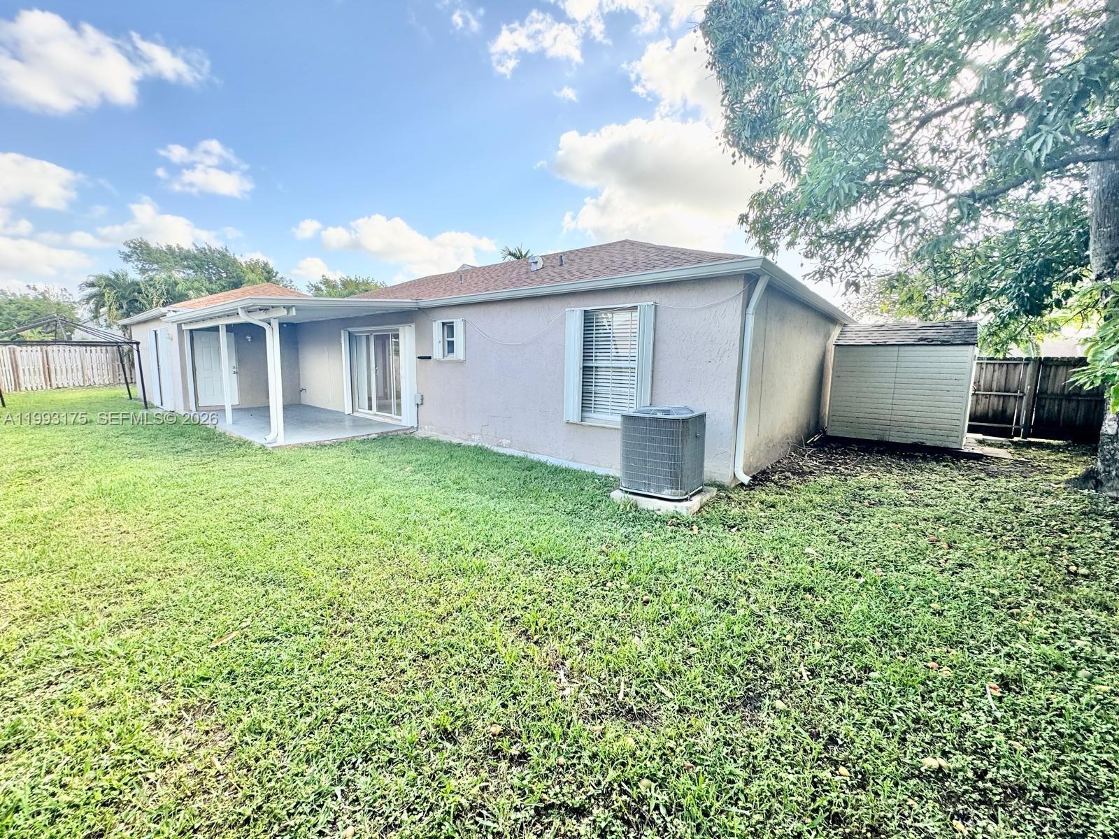 12695 Southwest 144th Terrace Miami, FL 33186 - Photo 42 of 43 a view of a house with yard and a garden