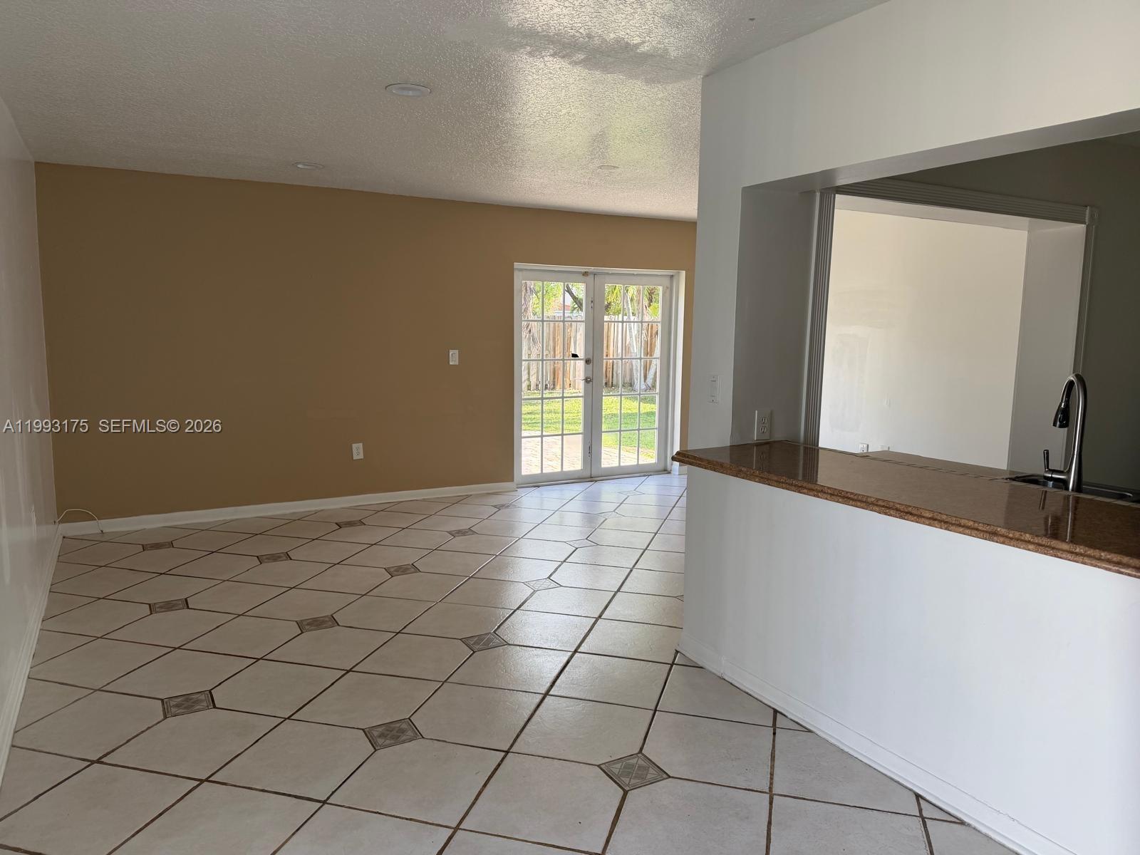 12695 Southwest 144th Terrace Miami, FL 33186 - Photo 5 of 43 a view of a livingroom with wooden floor and natural light