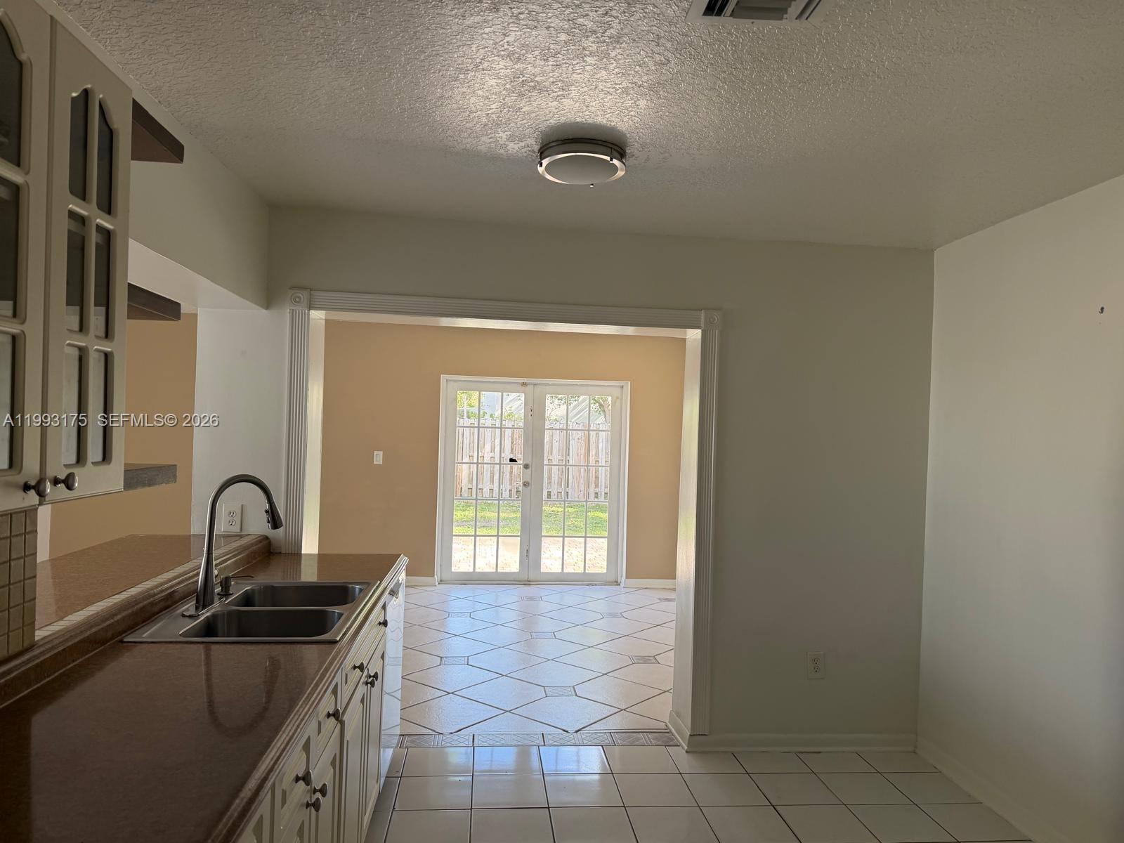 12695 Southwest 144th Terrace Miami, FL 33186 - Photo 6 of 43 a kitchen with a sink and a stove top oven