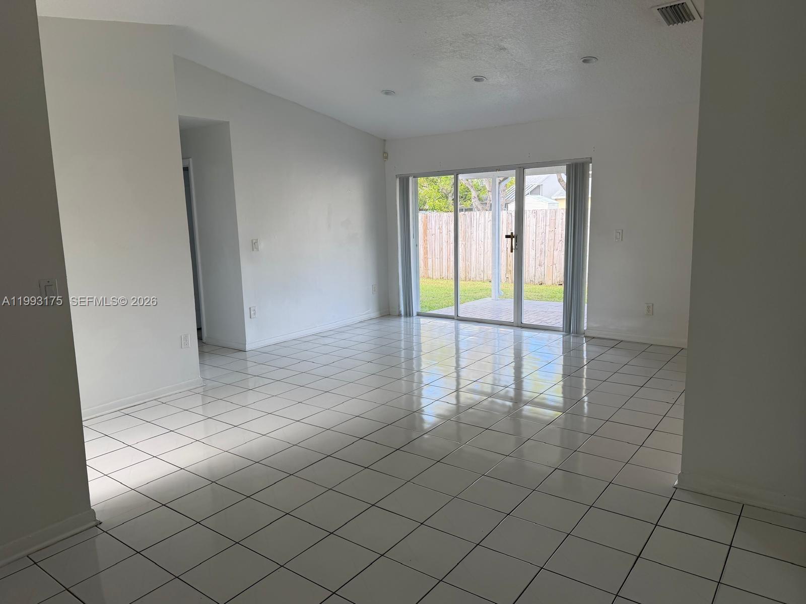 12695 Southwest 144th Terrace Miami, FL 33186 - Photo 9 of 43 a view of an empty room and window