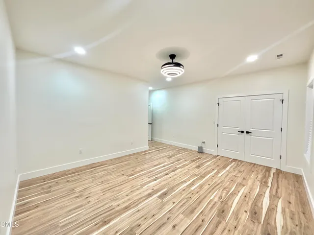 a view of an empty room and wooden floor