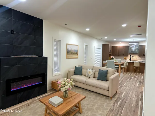 a living room with furniture and a fireplace