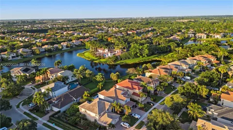 an aerial view of residential houses with outdoor space and swimming pool