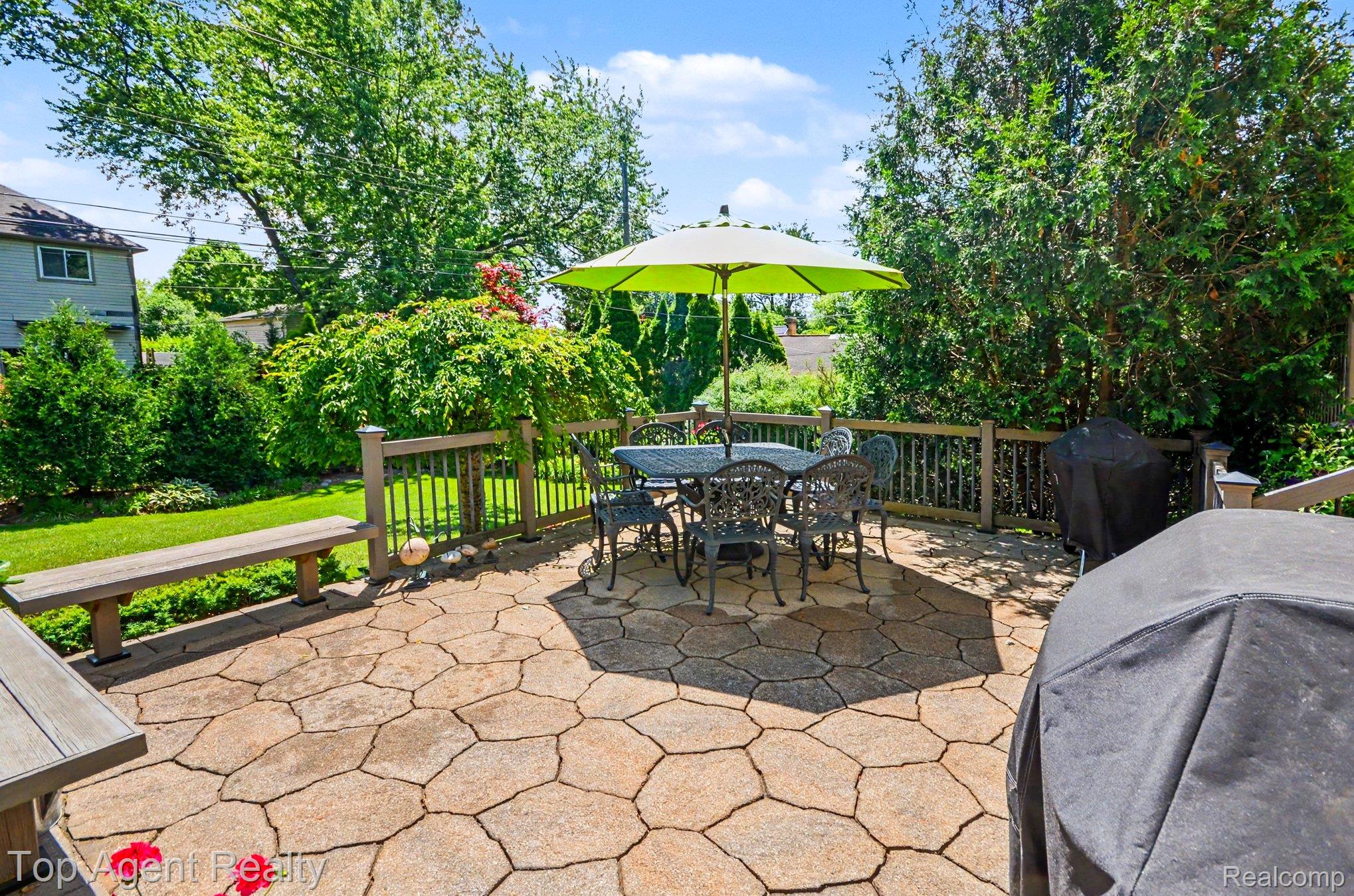 3759 Donley Avenue Rochester, MI 48309 - Photo 19 of 29 Expansive patio featuring flagstone paving, a wood-finish fence, and a built-in wood-finish bench