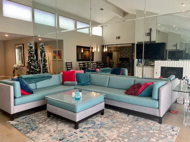 a kitchen with a sink dishwasher and a fireplace with chair