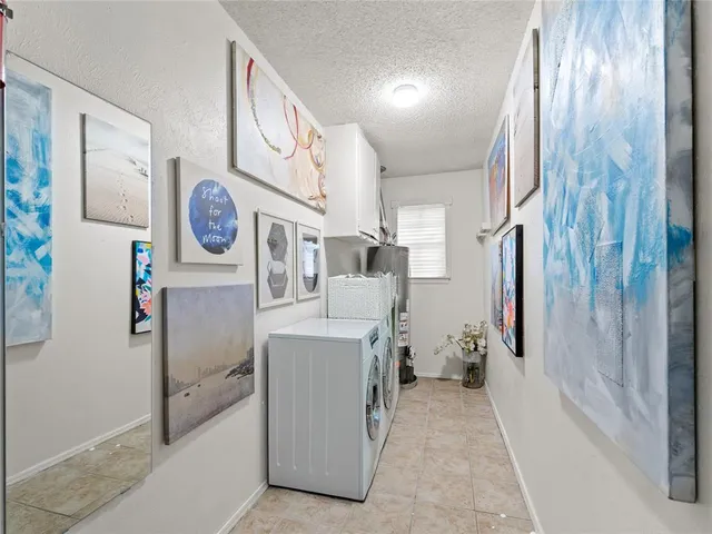 a view of a hallway with washer and dryer