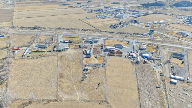 718 South State Street Genola, UT 84655 - Photo 11 of 19 Aerial perspective showcasing multiple structures, extensive surrounding land, and multiple outbuildings