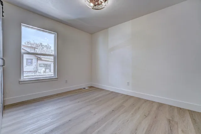 a bathroom with a granite countertop double vanity sink and a mirror
