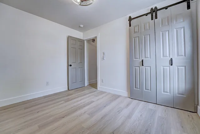 a view of a room with wooden floor and window
