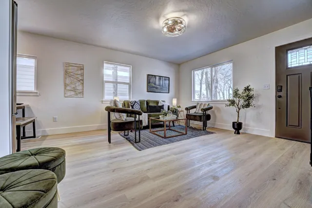 a kitchen with a refrigerator and a wooden floor