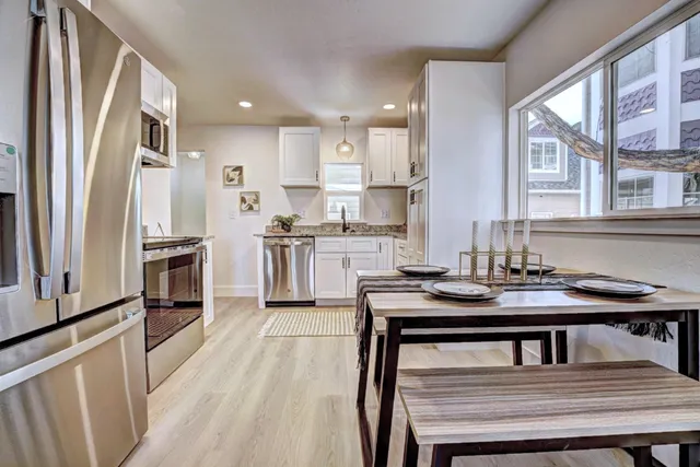 a kitchen with stainless steel appliances a stove microwave and sink
