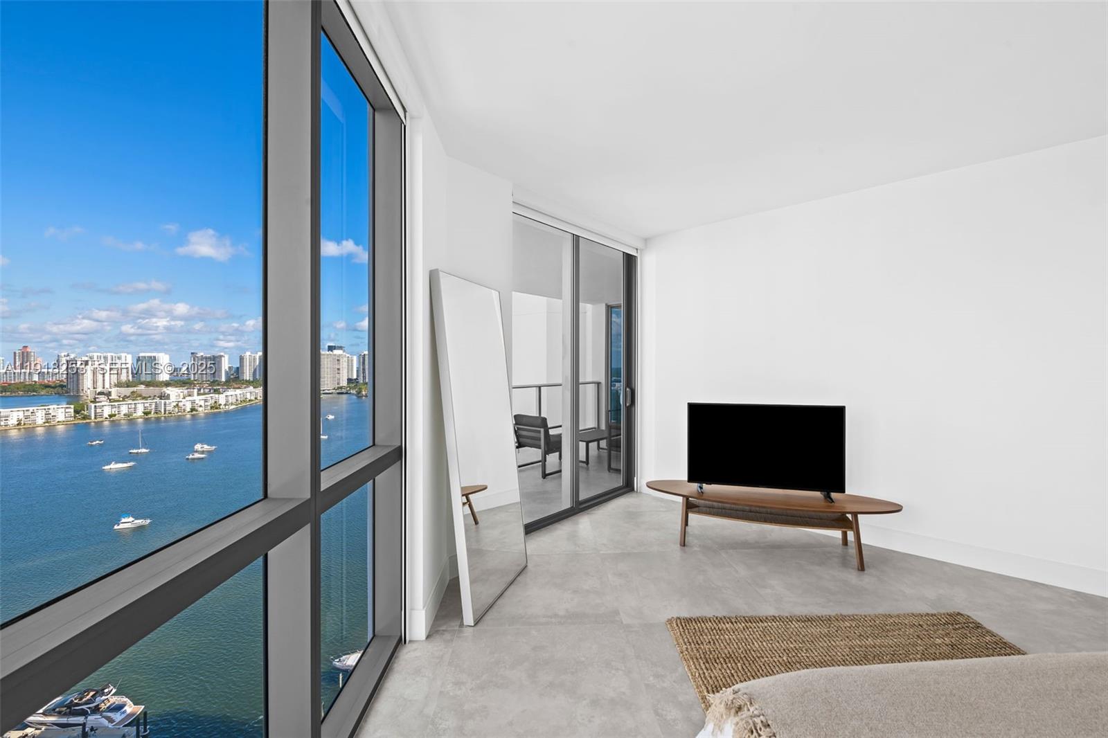 17111 Biscayne Boulevard, Unit 2103 North Miami Beach, FL 33160 - Photo 11 of 33 a living room with furniture and a flat screen tv
