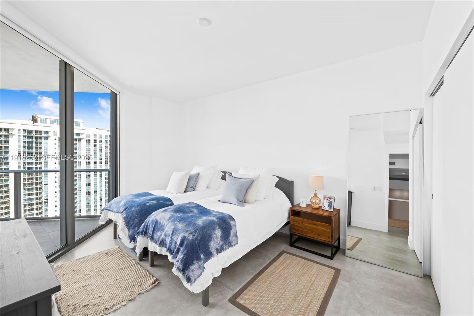 17111 Biscayne Boulevard, Unit 2103 North Miami Beach, FL 33160 - Photo 16 of 33 a bedroom with a bed and large window