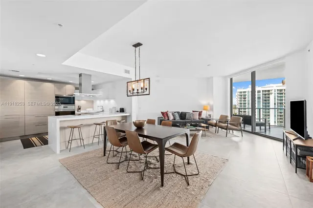 a view of a dining room with furniture a chandelier and wooden floor