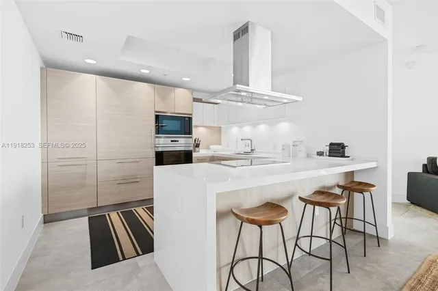 a kitchen with sink cabinets and microwave