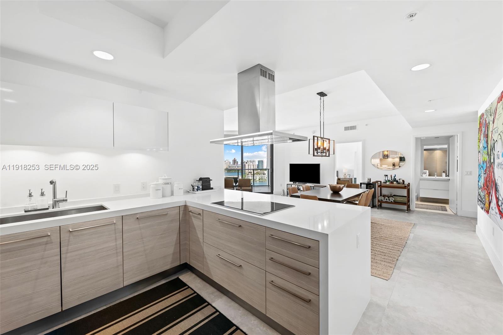 17111 Biscayne Boulevard, Unit 2103 North Miami Beach, FL 33160 - Photo 7 of 33 a kitchen with sink cabinets and living room view