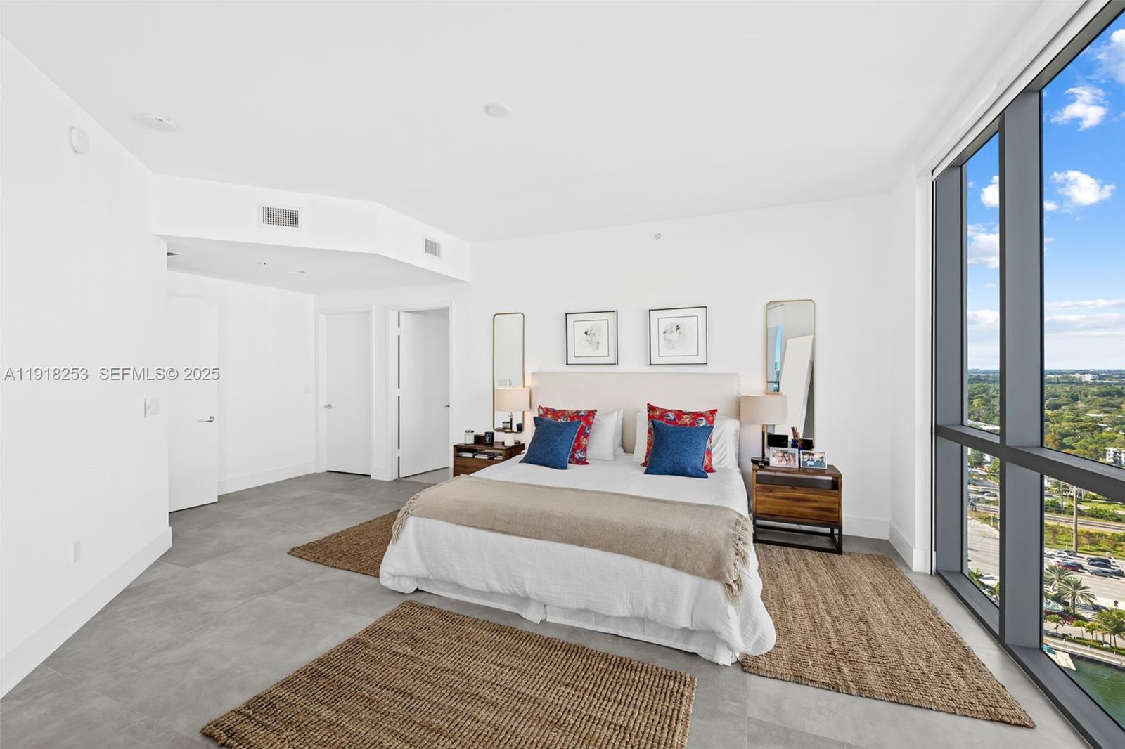 17111 Biscayne Boulevard, Unit 2103 North Miami Beach, FL 33160 - Photo 10 of 33 a bedroom with a bed and a large window