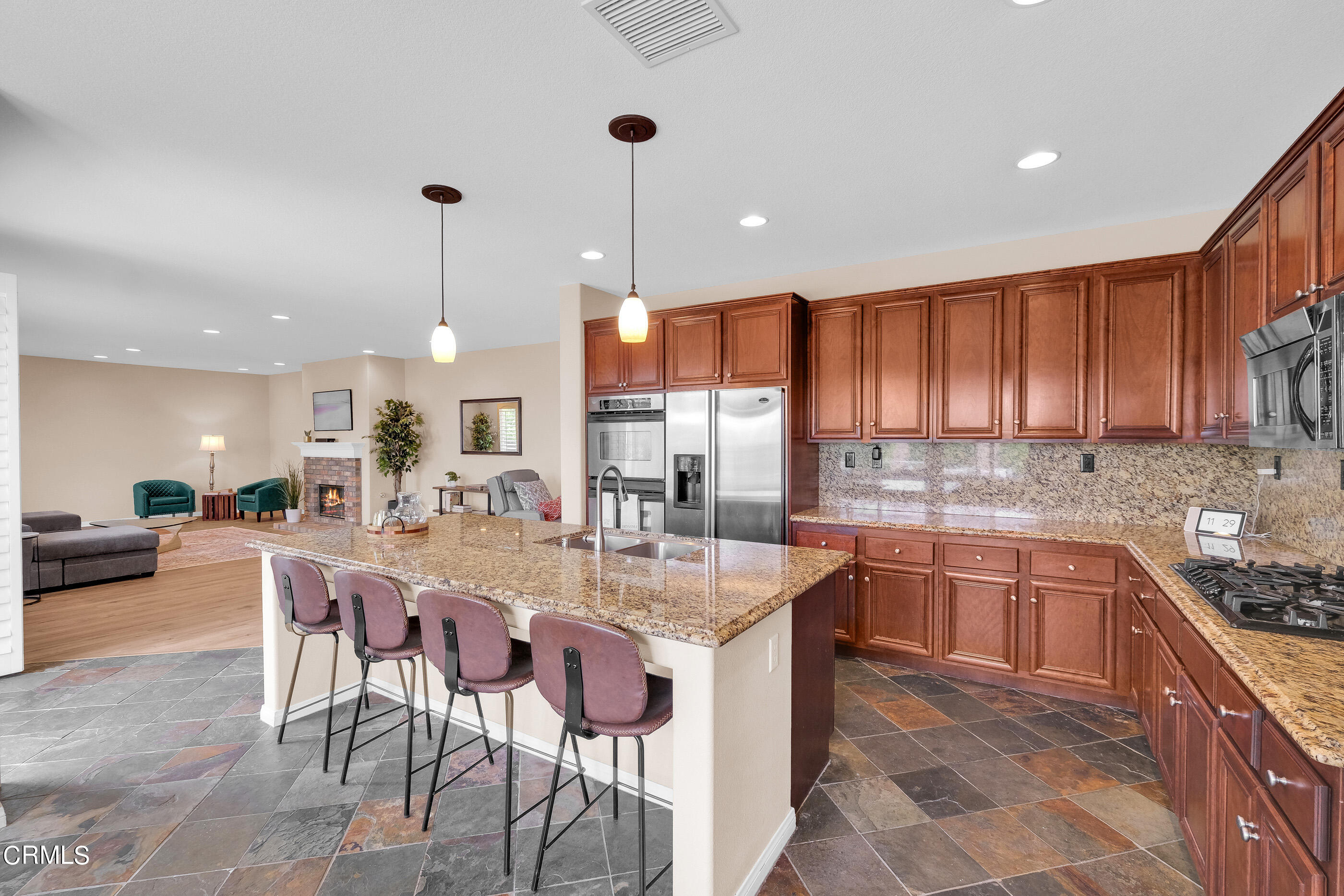 8317 Carriage Court Riverside, CA 92508 - Photo 14 of 37 a large kitchen with a table and chairs
