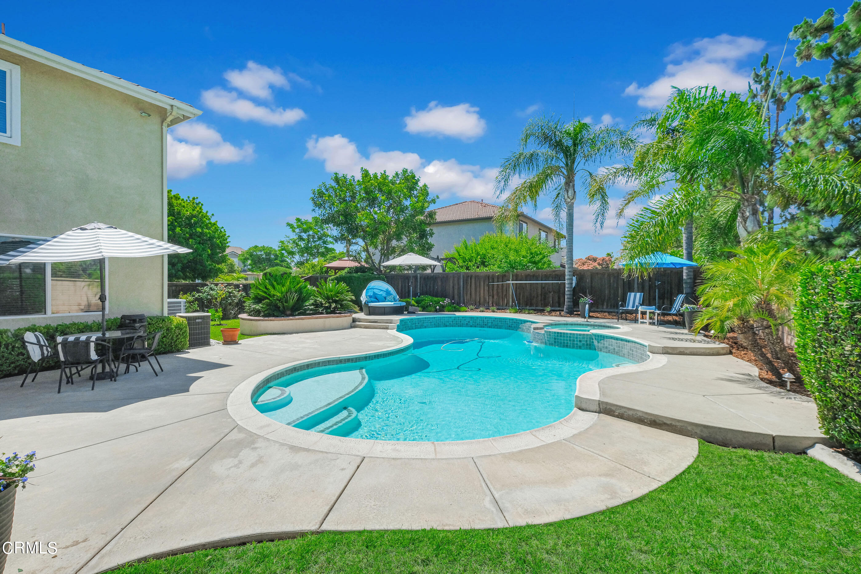 8317 Carriage Court Riverside, CA 92508 - Photo 2 of 37 a view of a swimming pool with a table and chairs under an umbrella