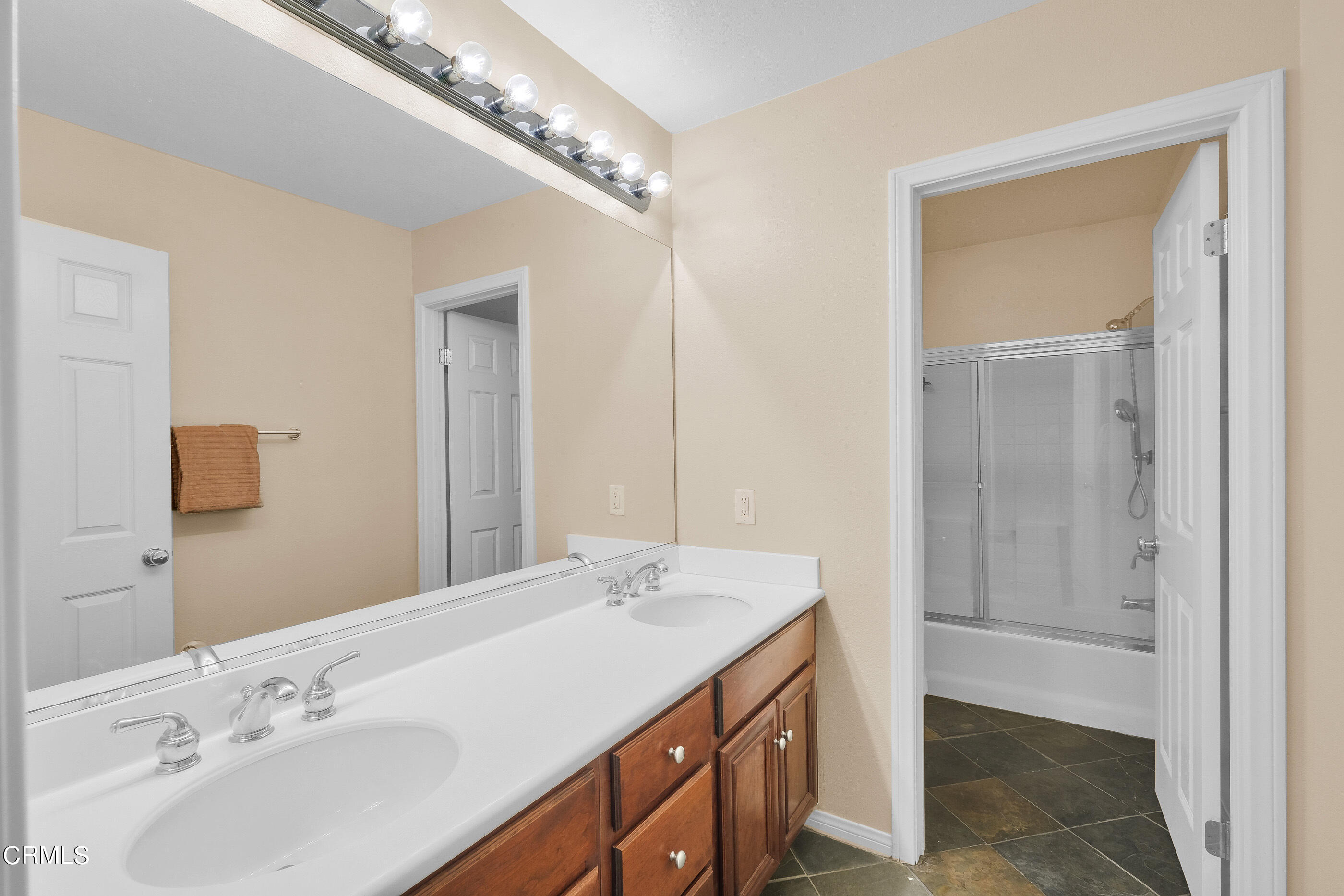 8317 Carriage Court Riverside, CA 92508 - Photo 21 of 37 a bathroom with a double vanity sink and a mirror