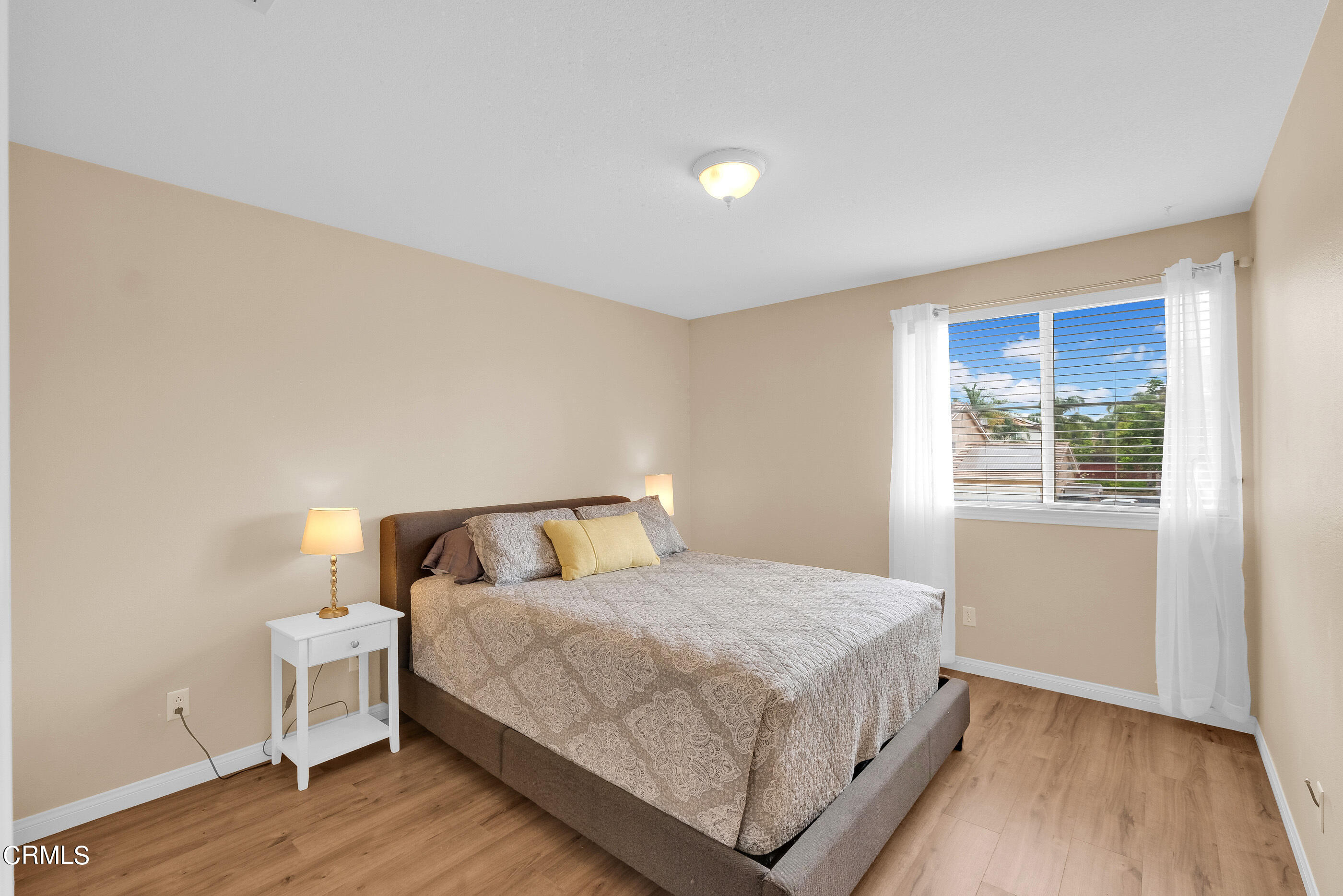 8317 Carriage Court Riverside, CA 92508 - Photo 22 of 37 a bedroom with a bed and wooden floor