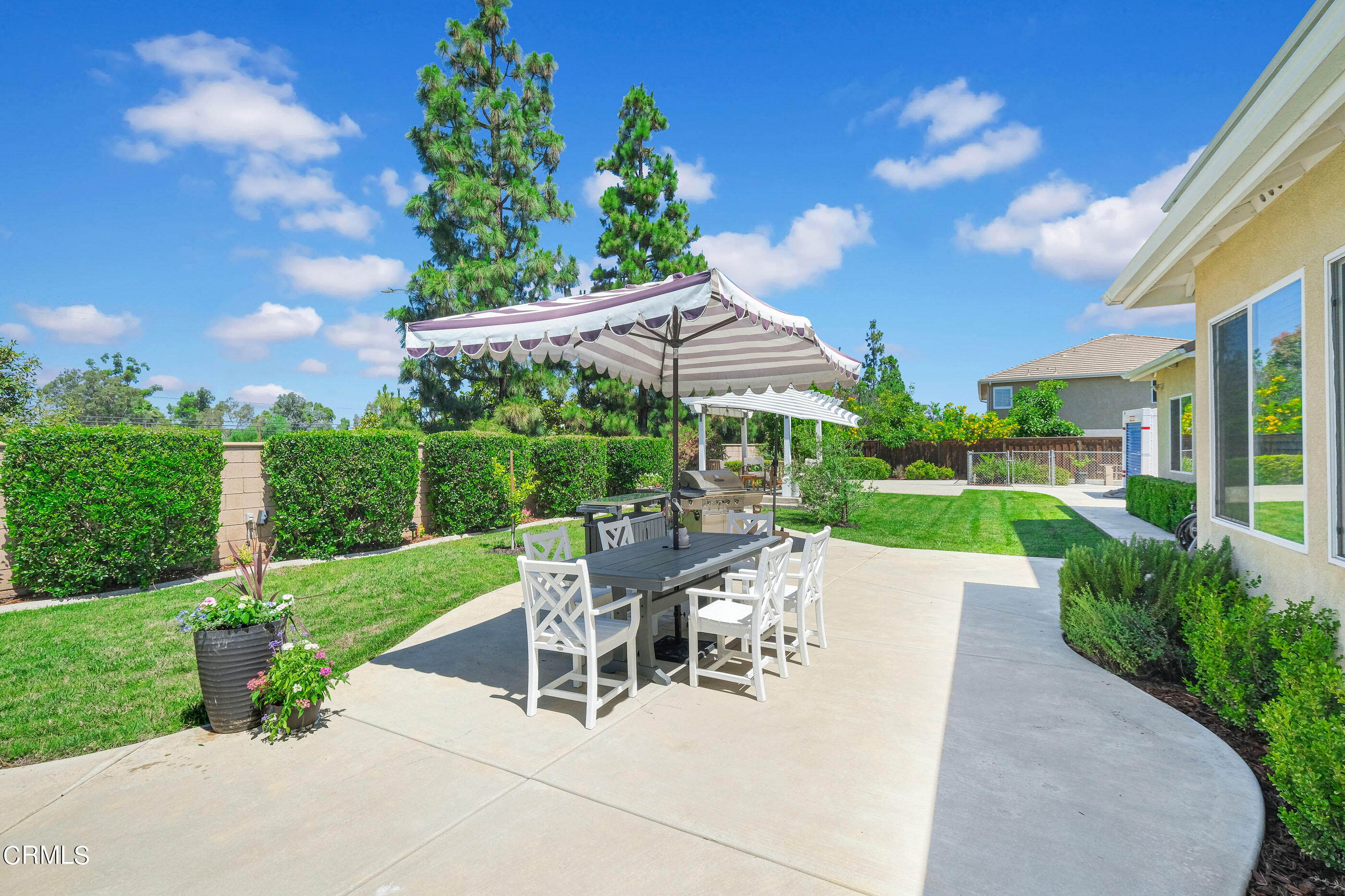 8317 Carriage Court Riverside, CA 92508 - Photo 31 of 37 a view of a patio with a table and chairs under an umbrella
